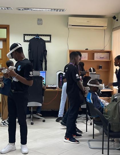 Young boys being shown how to use head mounted display for virtual reality